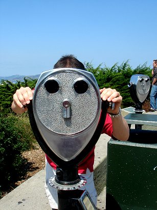 Looking through the binoculars. Coit Tower, San Francisco