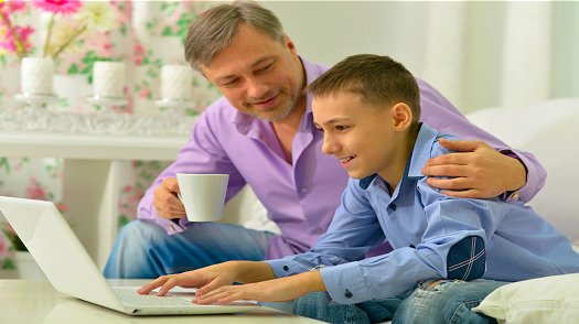 Father and son working on a laptop together