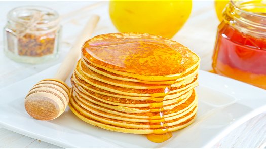 Stack of pancakes with honey
