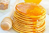 Stack of pancakes and golden syrup for Pancake Day