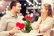 Valentine’s Day couple giving gifts of roses and chocolates